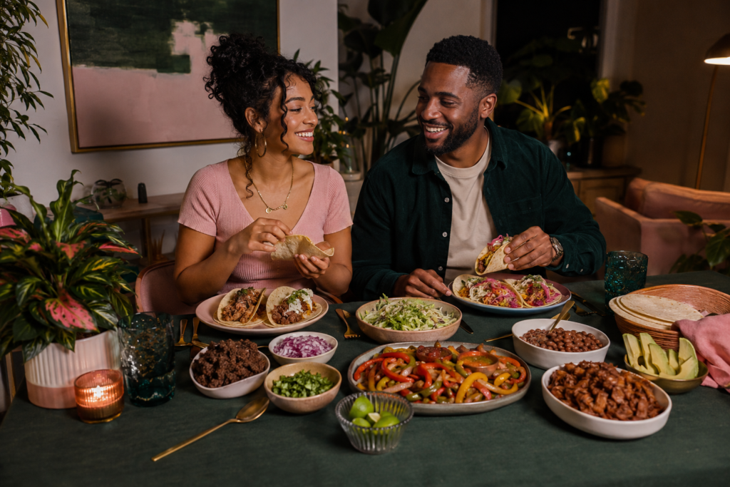 plant-based-parallel-meals-mixed-household A cozy taco night table with plant-based fillings and traditional options showing how to eat around meat in a mixed household.