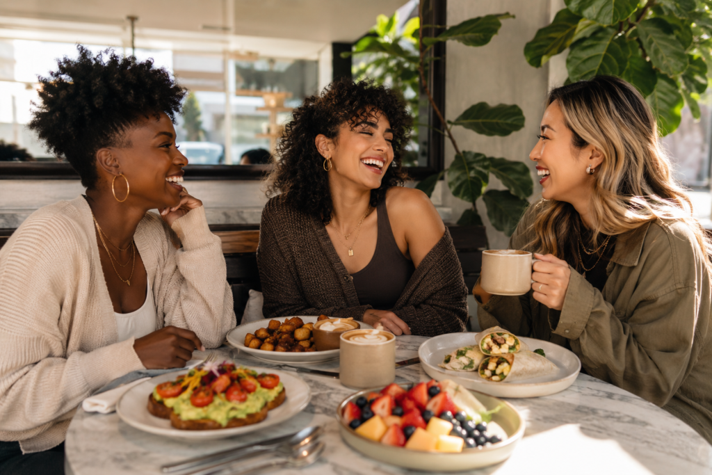 Friends enjoying flexible plant-based brunch options in a bright modern café.