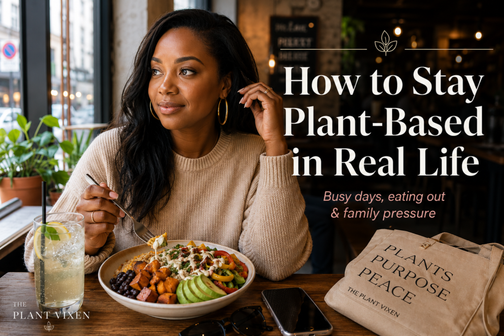 Stylish woman eating a colorful plant-based bowl at a cozy café while learning how to stay plant-based in real life.