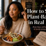 Stylish woman eating a colorful plant-based bowl at a cozy café while learning how to stay plant-based in real life.