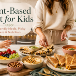 Kid-friendly plant-based meal spread with dairy-free grilled cheese, tomato soup, fruit, hummus, and pretzels in a cozy kitchen.