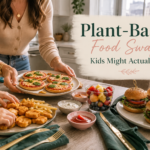 Kid-friendly plant-based food swaps including mini pizzas, meatless nuggets, fries, sliders, fruit, and dipping sauces on a cozy family table.