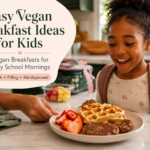 Child getting ready for school as a parent serves vegan waffles, breakfast sausage, and strawberries in a cozy kitchen.